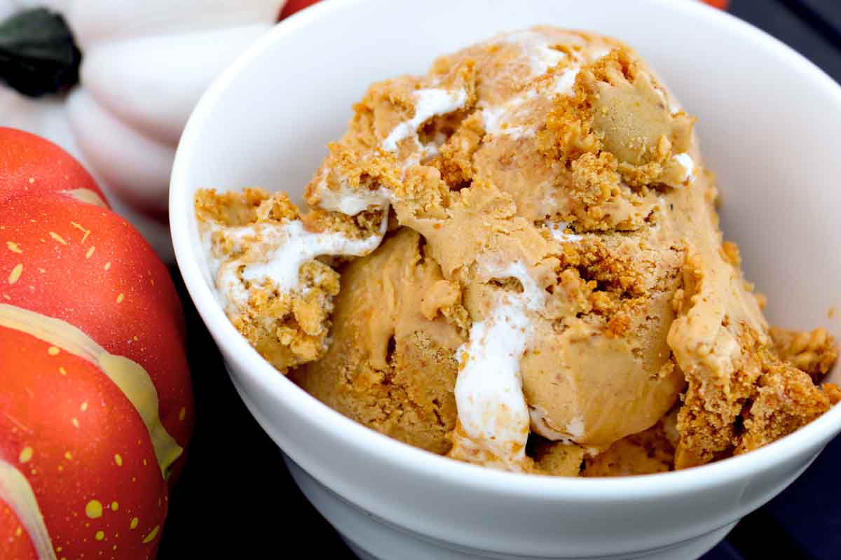 A bowl of Pumpkin Meringue Pie Ice Cream with a scoop