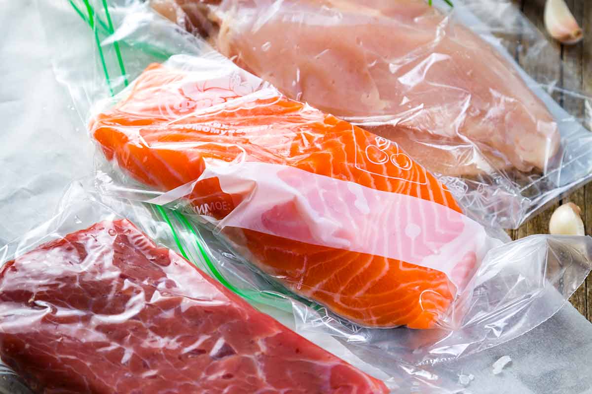 Vacuum sealed pieces of salmon, chicken, and steak.