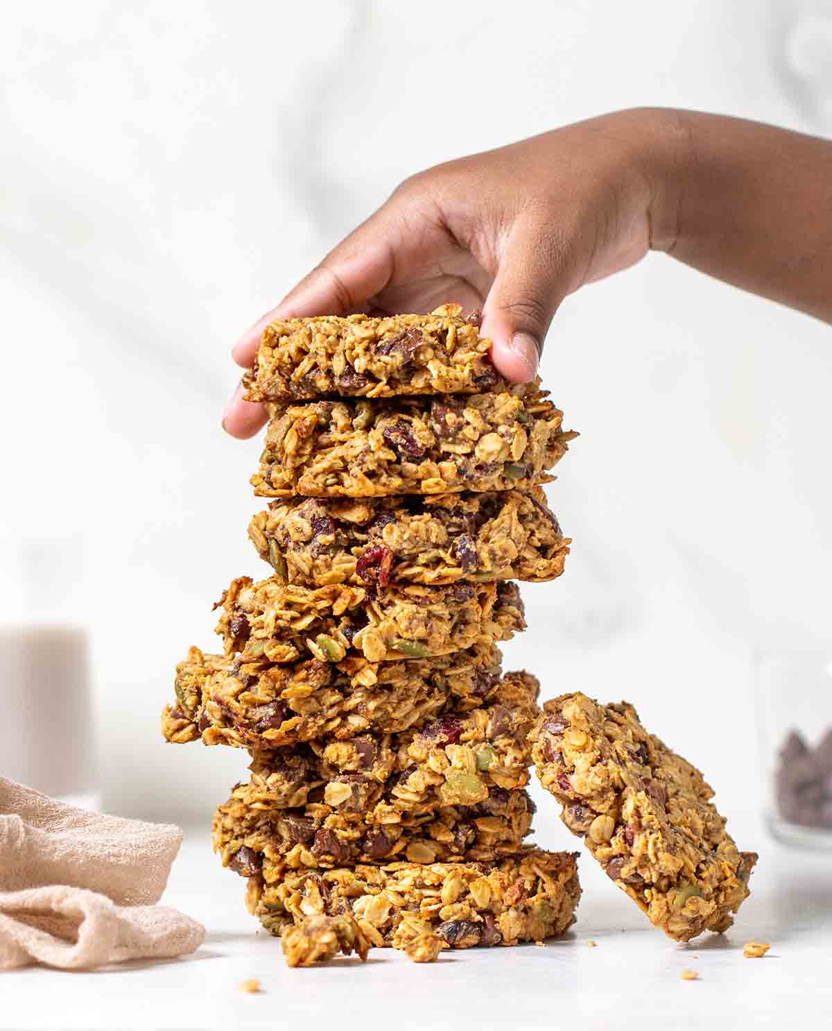 A woman's hand piling up superfood breakfast cookies