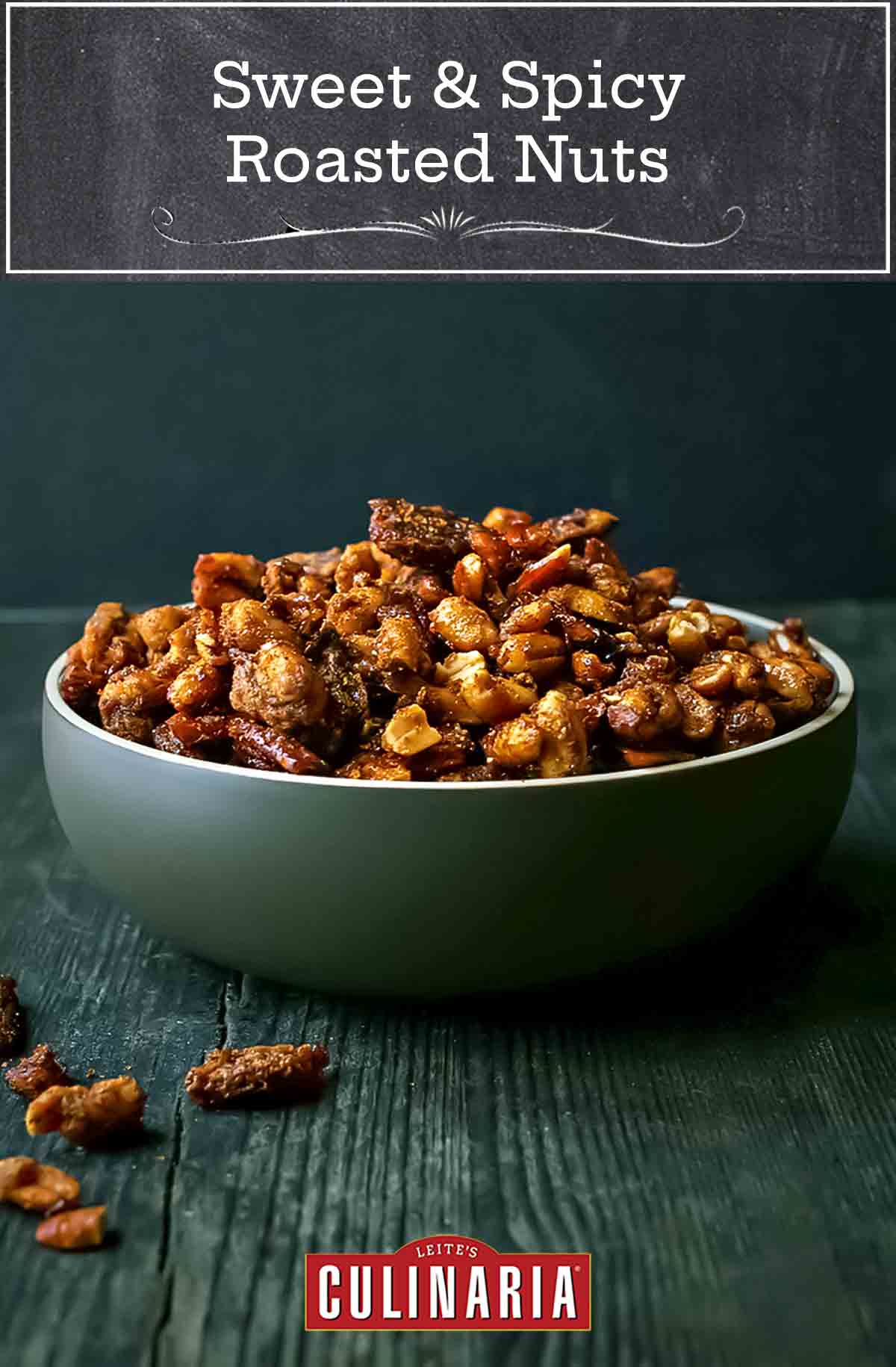 Sweet and spicy roasted nuts in a large green bowl on a wooden table.