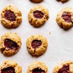Eleven barley thumbprint cookies on parchment