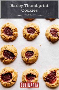 Eight barley thumbprint cookies on parchment