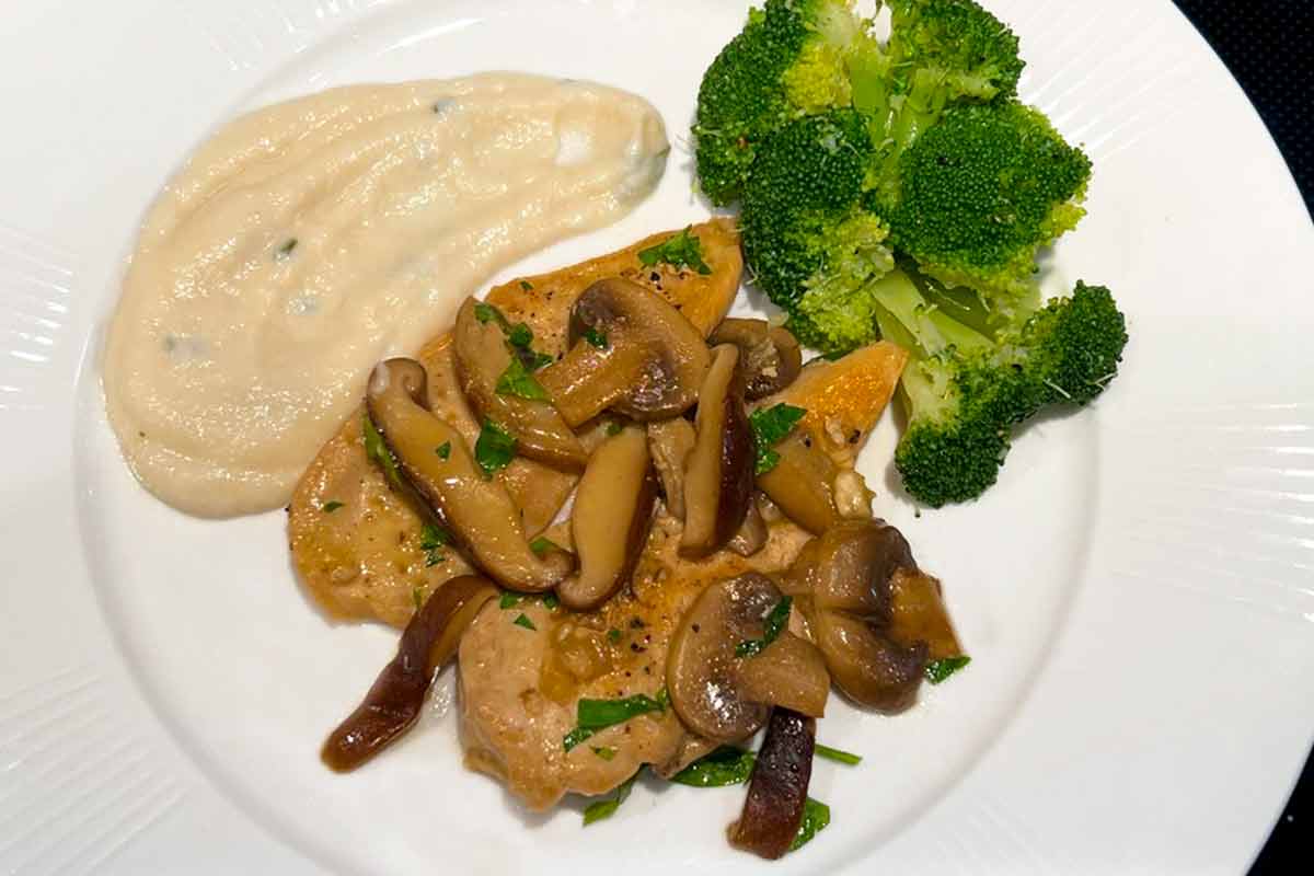 A white plate with a portion of easy keto chicken Marsala