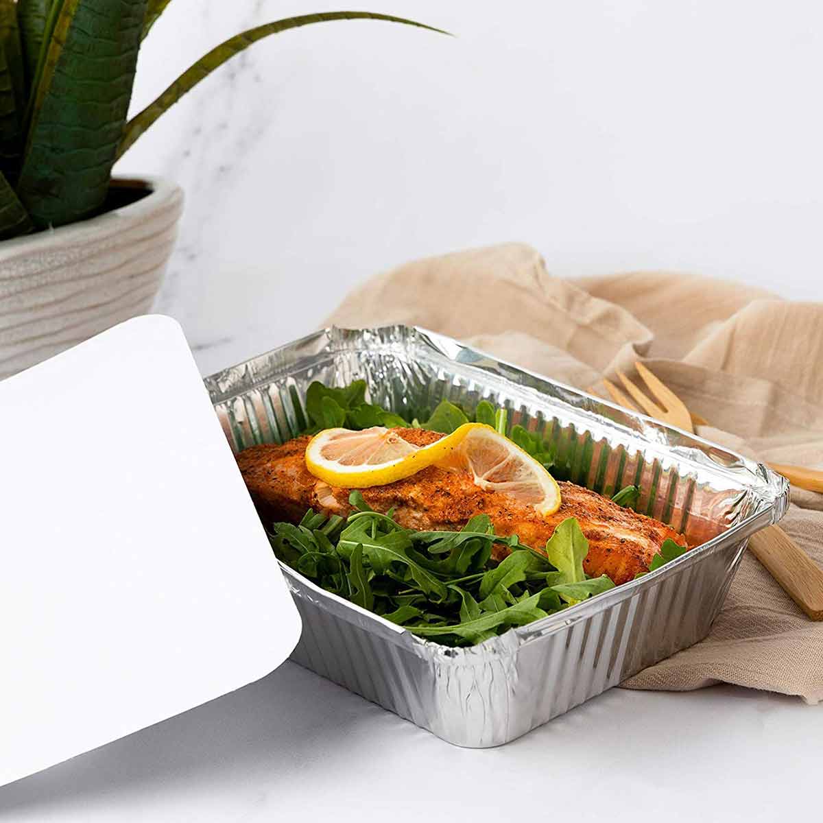 A disposable aluminum pan filled with salmon ready to be frozen