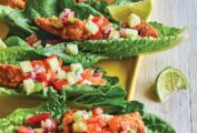 Four low-carb fish tacos--almond-meal coated cod and cucumber salsa in lettuce leaves--with a slice of lime. You're gonna love these babies!