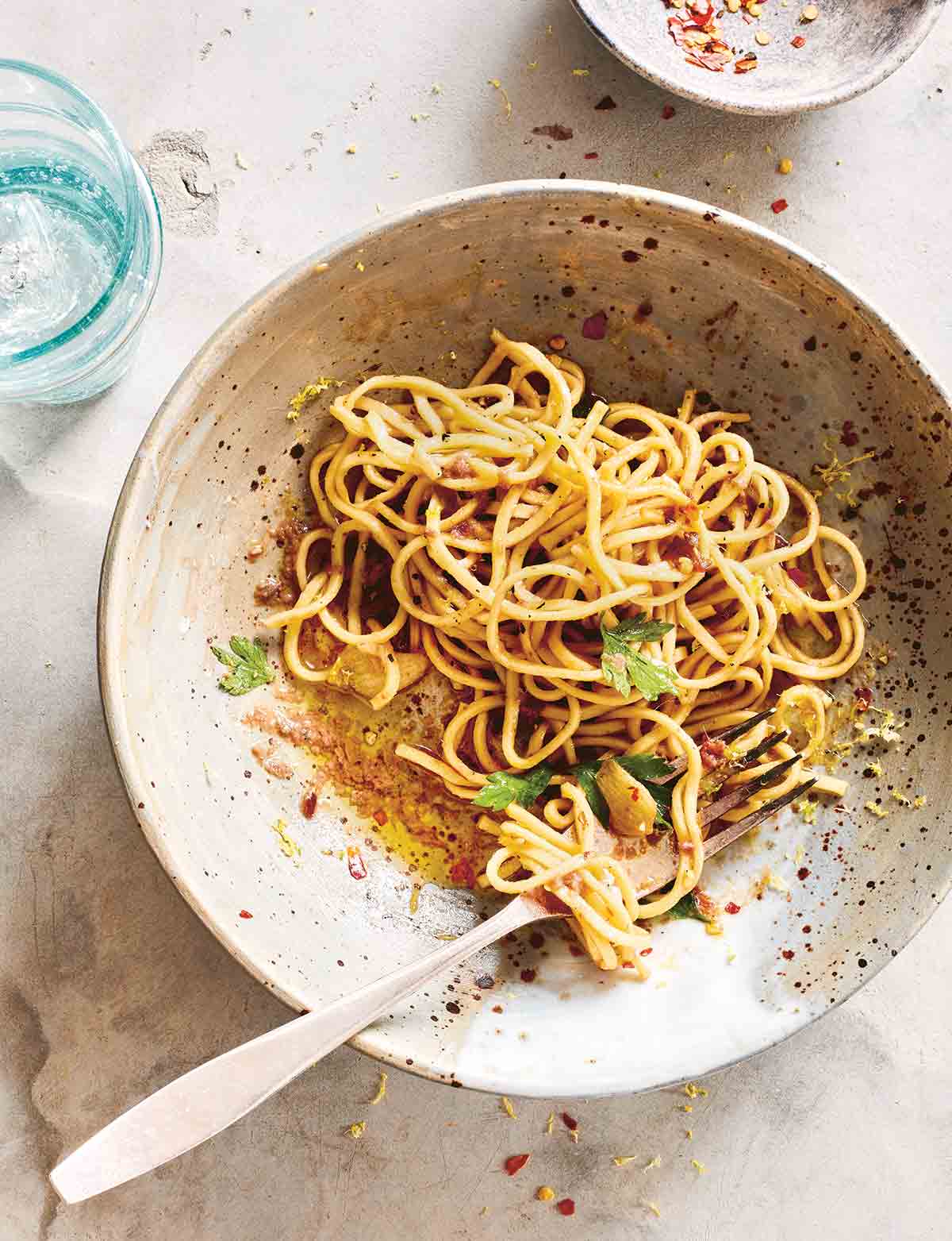 A bowl of spaghetti with anchovy and lemon