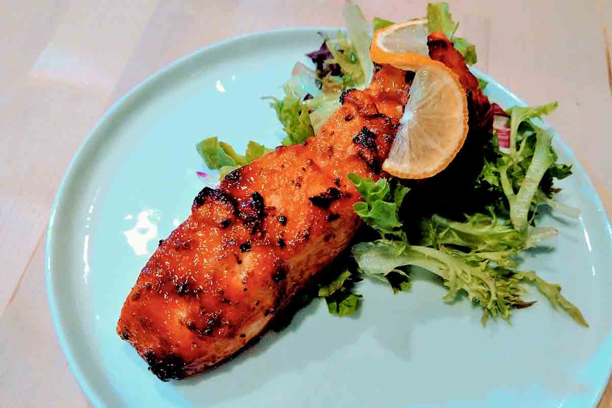 A blue plate with air fryer miso-glazed salmon