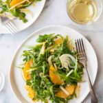 Two plates of apple, fennel, and orange salad