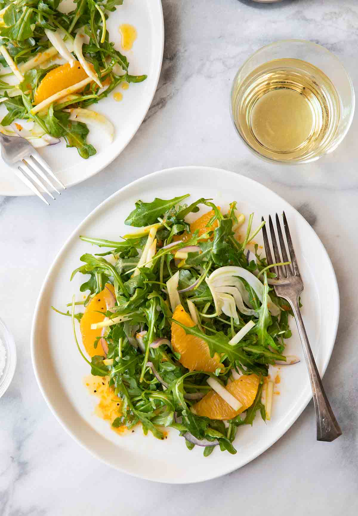 Two plates of apple, fennel, and orange salad