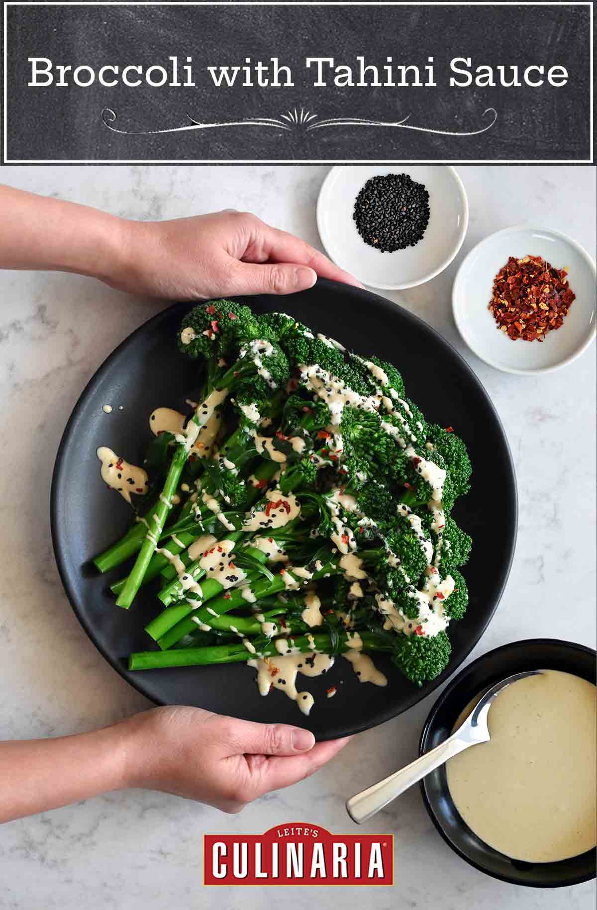 A black plate with broccolini with tahini sauce