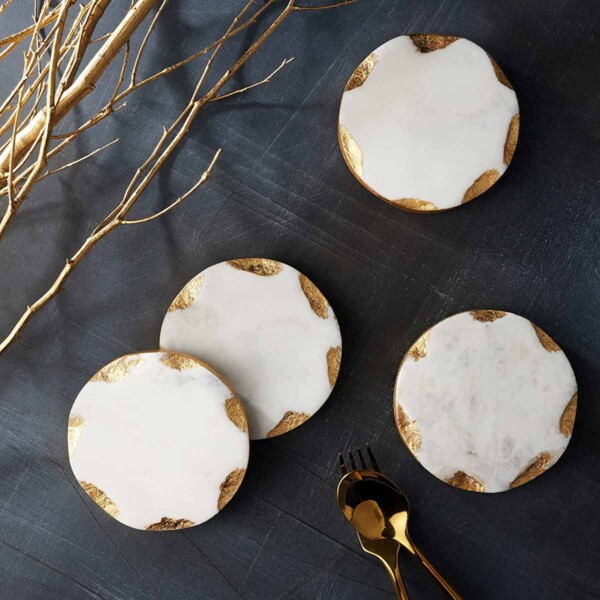 Godinger Gold Edge Marble Coasters set of four on dark tabletop.