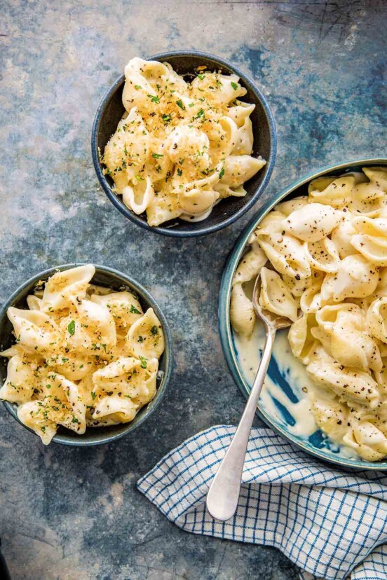Three blue bowls of Instant Pot mac and cheese