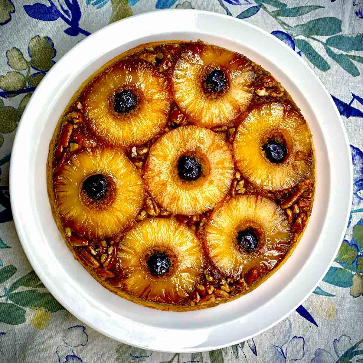 A pineapple upside-down cake on a white plate