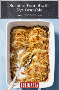 a white casserole dish of roasted fennel with rye crumble