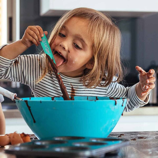 Silicone Jar Spatula with little girl licking the spoon.