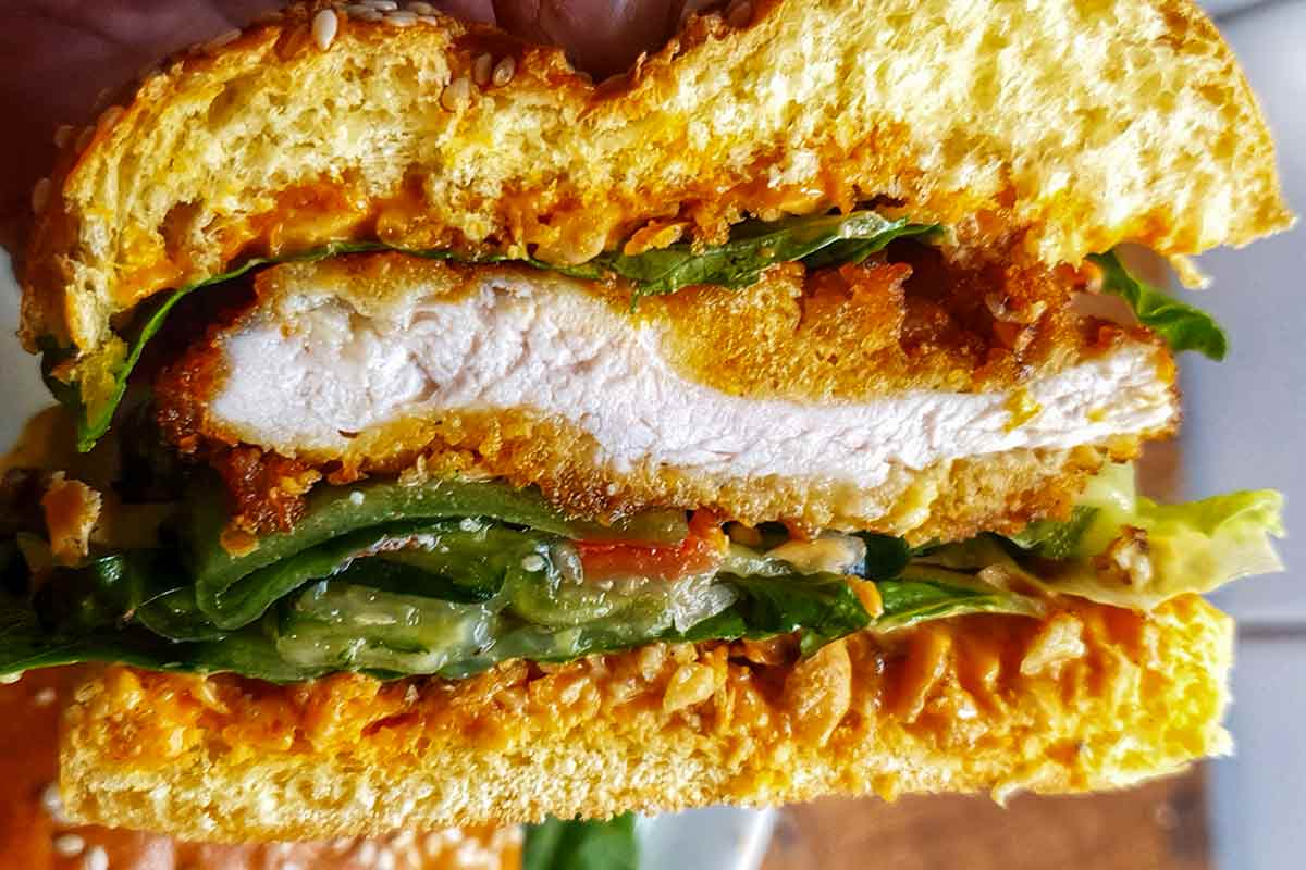 A cornflake chicken sandwich cut in half to show the middle.