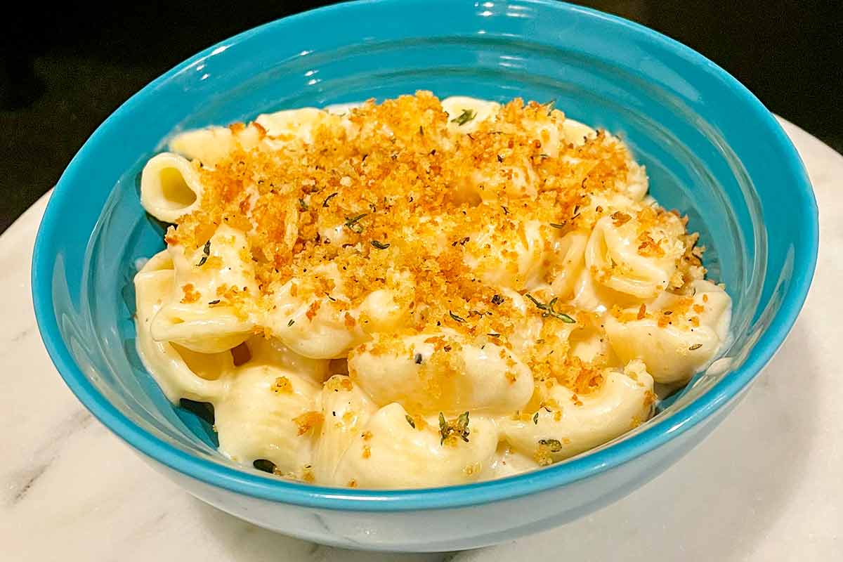 A blue bowl of Instant Pot mac and cheese