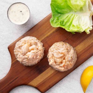 Rastelli's Crab Cakes on wooden board with lettuce.