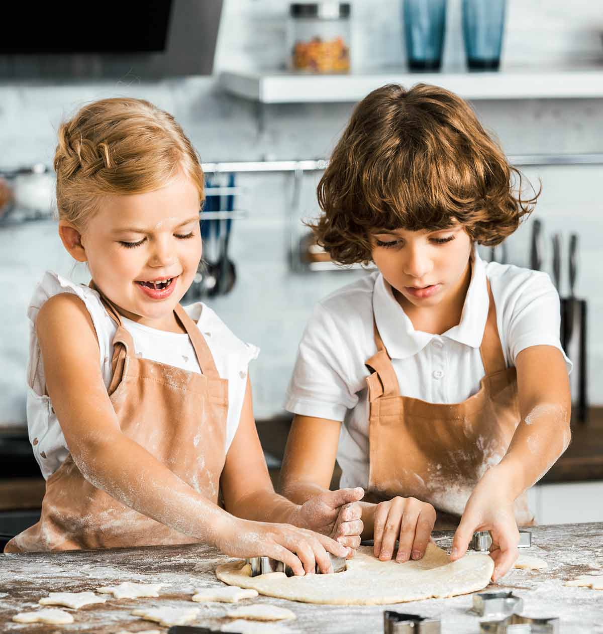 Two kids cooking and baking on a kitchen