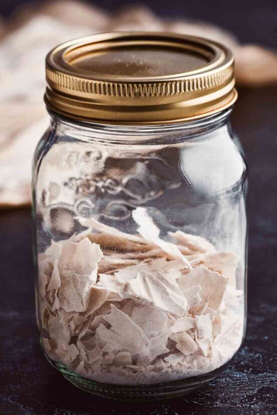 A jar of flaked dried sourdough starter
