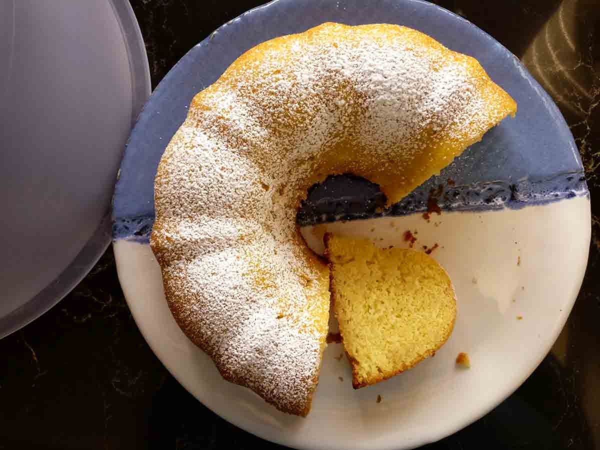A partially cut Kentucky butter cake on a blue and white plate