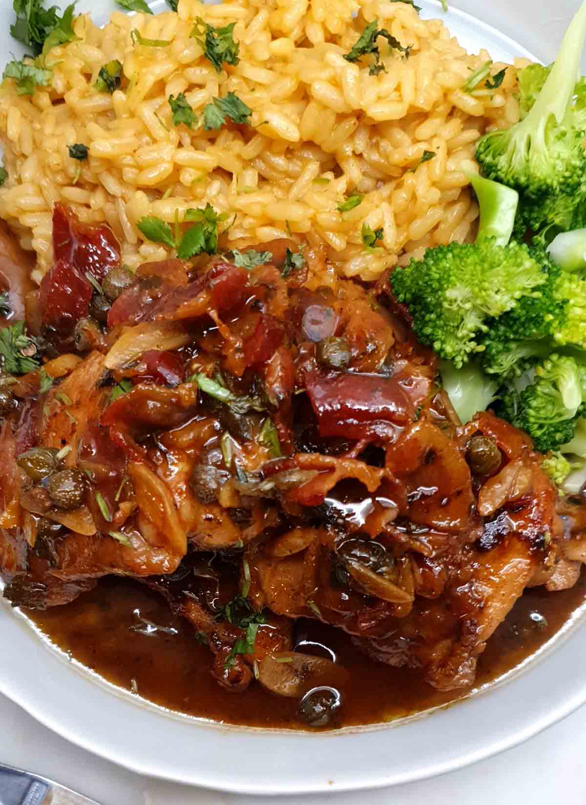 A plate of quick skillet chicken with bacon, steamed broccoli, and rice.