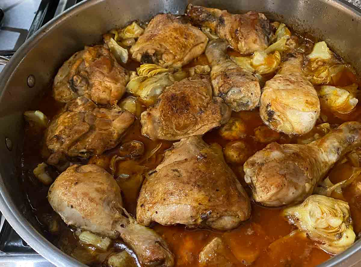 Sherry-braised chicken with artichoke hearts in a deep skillet