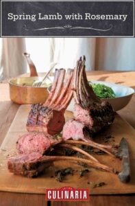 Cutting board with a sliced rack of spring lamb with rosemary, knife, bowl of salad