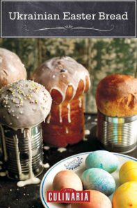 Four loaves of Ukrainian Easter bread, paska, with a bowl of colored eggs in front of them