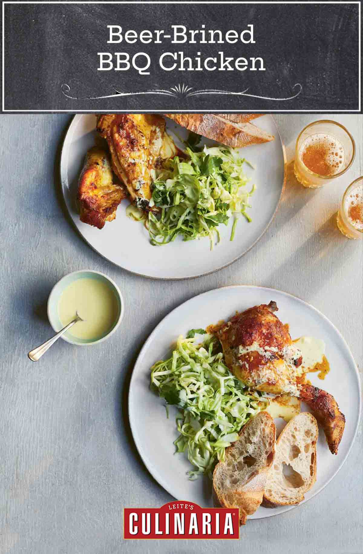 Two plates of beer-brined bbq chicken, shredded cabbage, and artisan bread, with a small bowl of dip between them.