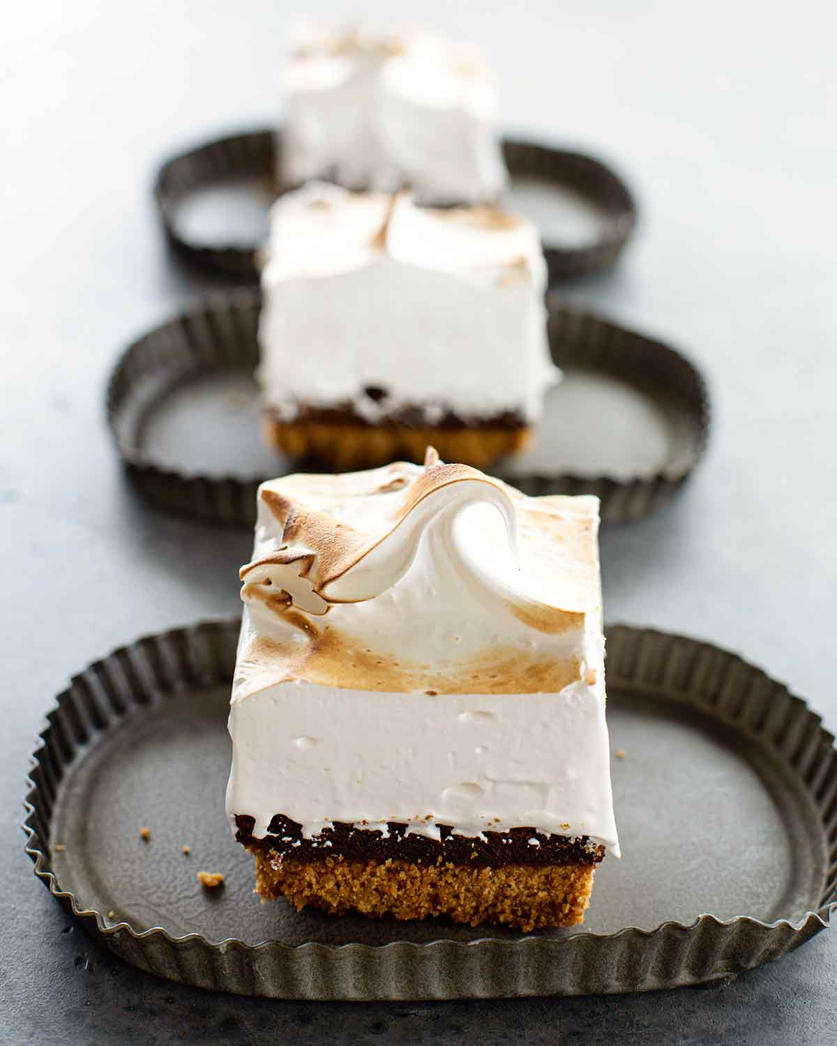 Three pieces of Cheryl Day's s'mores bars on individual fluted plates