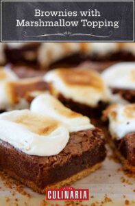 Individual brownies with toasted marshmallow topping on a baking sheet