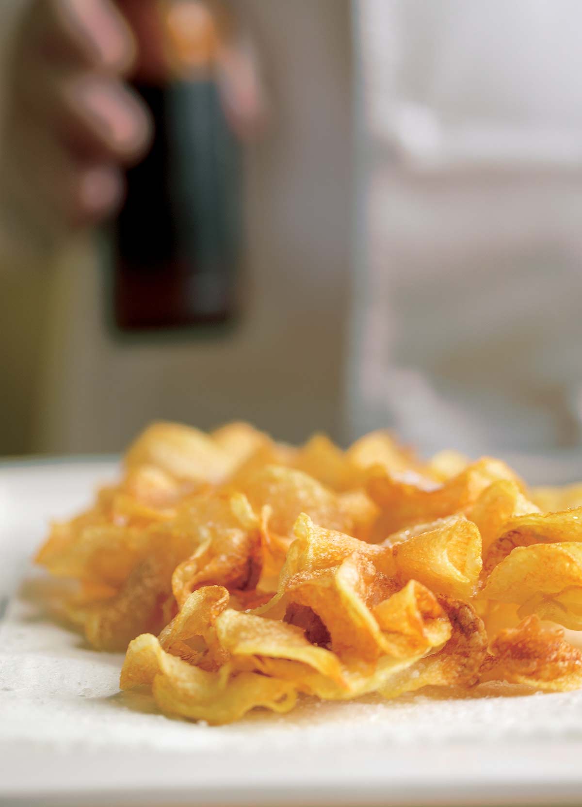 A pile of ribbon fries on a white surface.