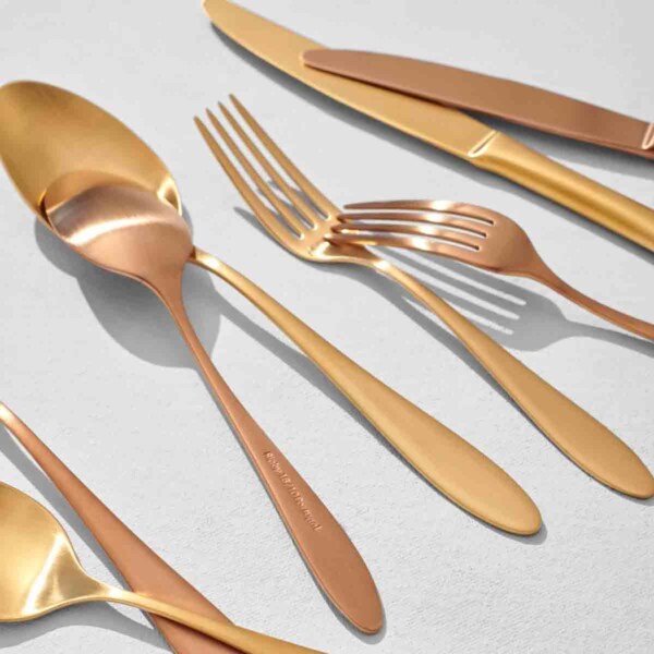 Rigby Home Flatware Set scattered on white background some upside down.