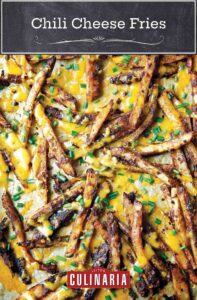 A scattering of chili cheese fries topped with cheddar and snipped fresh chives.