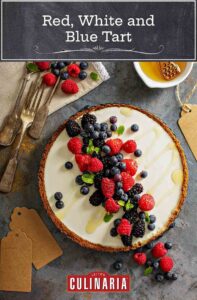 A red, white, and blue tart with a graham cracker crust, cream cheese filling, and raspberries, blueberries, and blackberry on top.