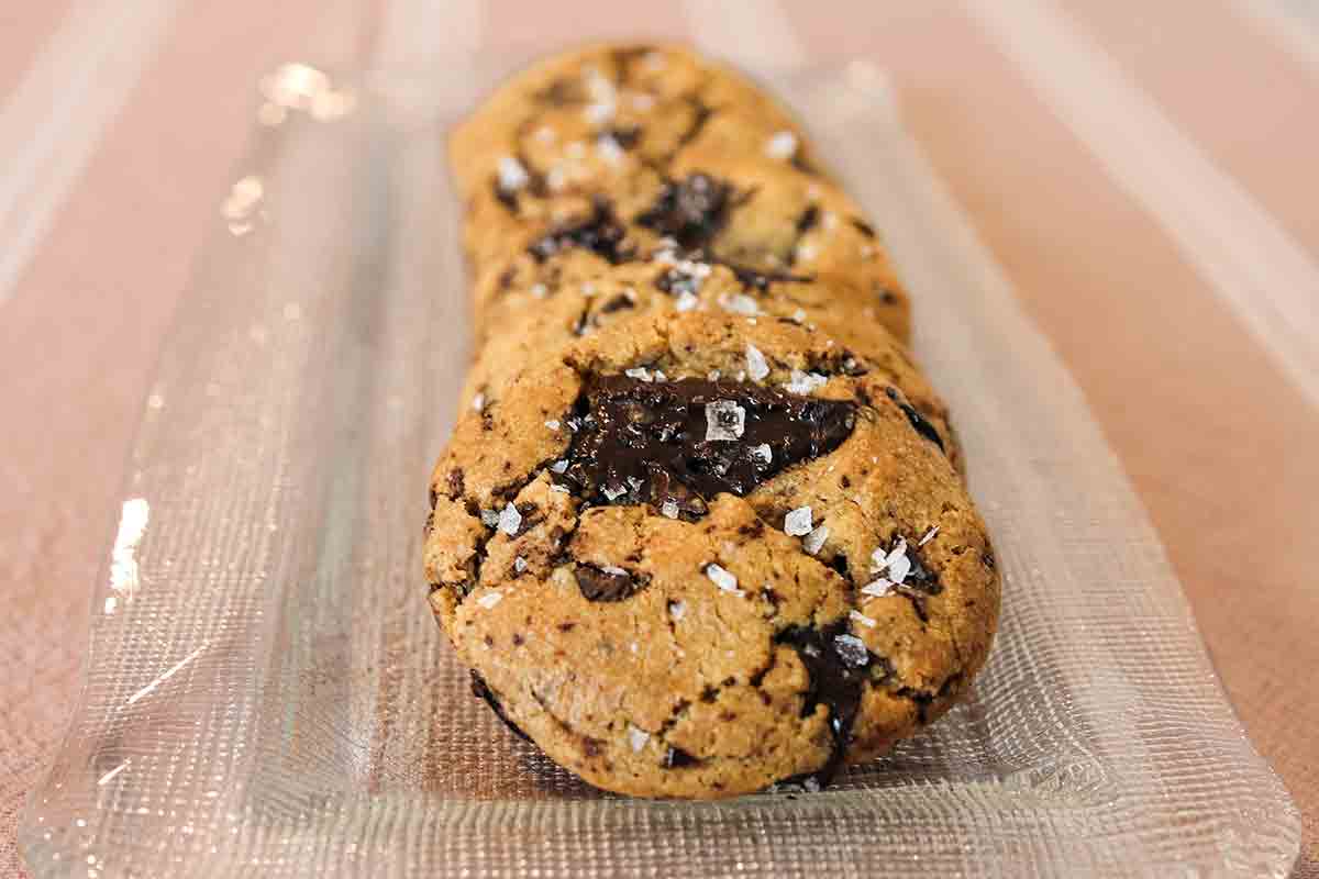 Salted brown butter chocolate chip cookies on a glass rectangular serving plate.