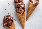 Three waffle cones, each filled with two or three scoops of chocolate Oreo ice cream.