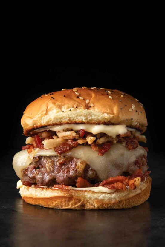 A skillet bacon cheeseburger with crispy fried onions.