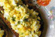 An open face egg salad sandwich on toasted whole wheat.