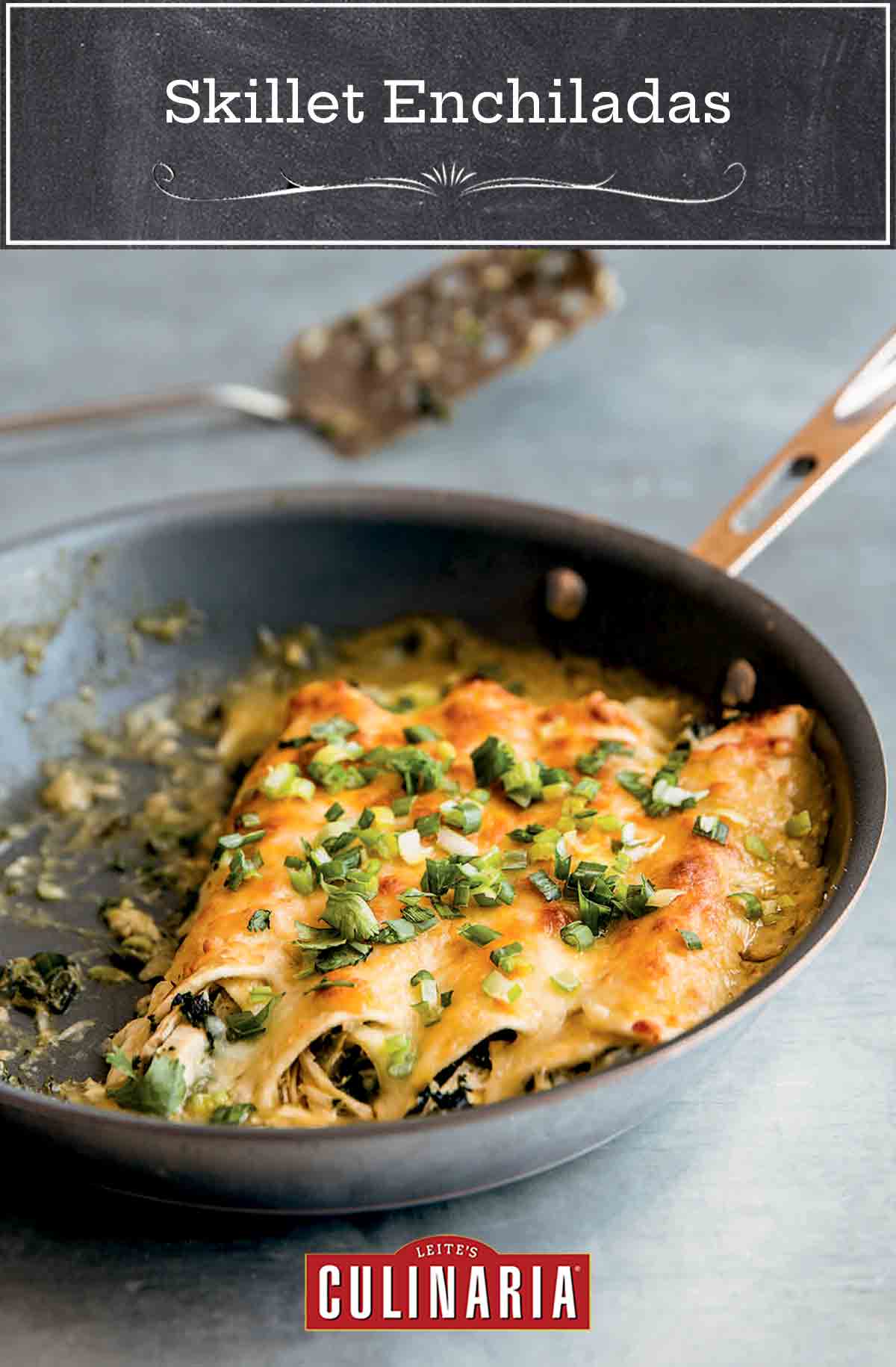 Four chicken enchiladas in a nonstick skillet, topped with scallions.