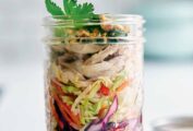 A glass jar filled with a layered Vietnamese chicken salad.