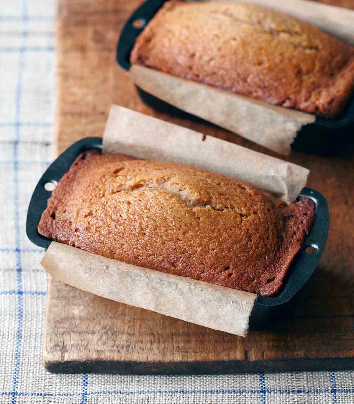 A loaf of applesauce bread in a parchment-lined loaf pan.