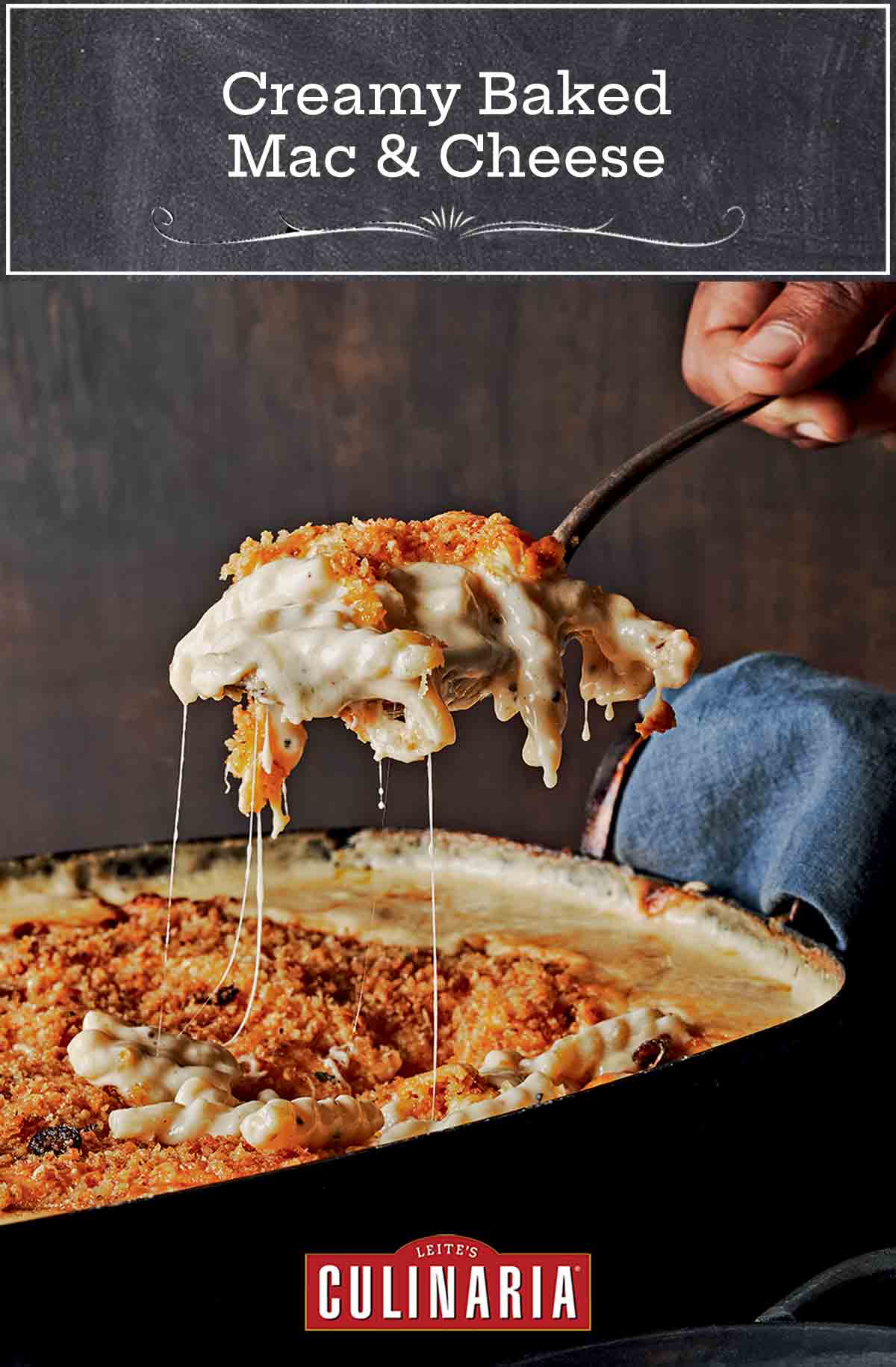 A scoop of creamy baked mac and cheese with crunchy topping being lifted from a casserole dish.