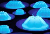 Several plates with fluorescent glowing Jello molds.
