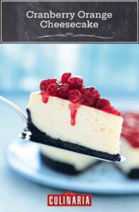 A slice of cheesecake topped with cranberries on a silver cake lifter.
