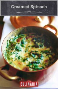 A copper pot filled with creamed spinach.