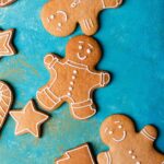 A selection of decorated gingerbread cookies in the shapes of men, stars, and trees.