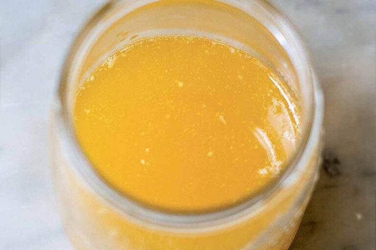 A glass jar with melted clarified butter or ghee.