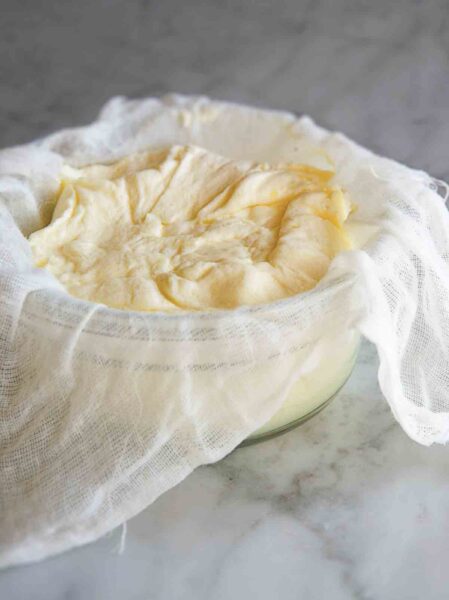 A bowl lined with cheese clith and filled with homemade mascarpone.